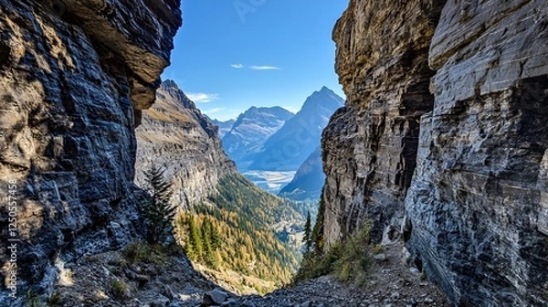 Fototapeta A narrow mountain pass carved into rocky cliffs with panoramic valley views below