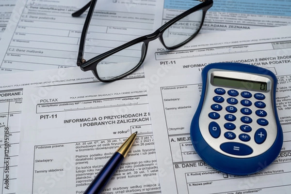 Fototapeta Polish individual income tax form PIT with pen calculator glasses on desk. Workplace