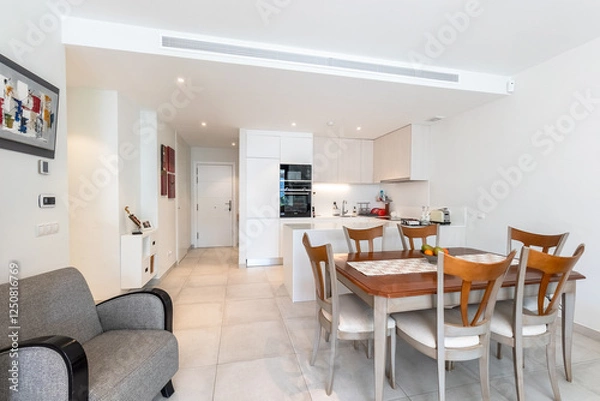 Obraz an open kitchen next to dining table in luxury mediterranean holiday home 