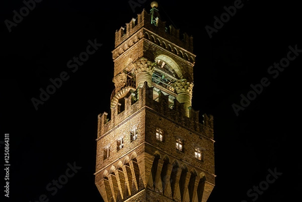 Fototapeta A nighttime view of the bell tower of the palazzo Vecchio of Florence