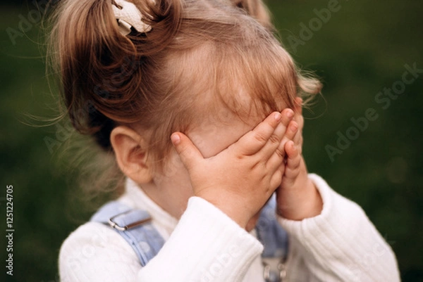 Fototapeta Little girl hiding her face