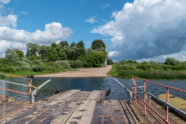 Fototapeta view from the ferry crossing to the water in the river and the road in summer