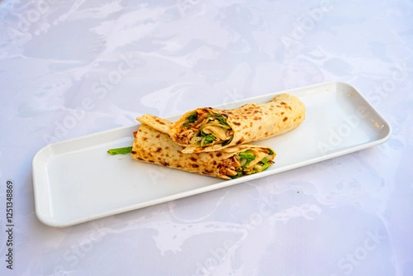 Fototapeta Lavash zurna doner kebab ( zurna  durum )  or shawarma sliced in plate isolated.  hatay usulu tavuk Et doner durum. Gobit ekmek arasi doner. Pilavustu iskender doner kebap. 