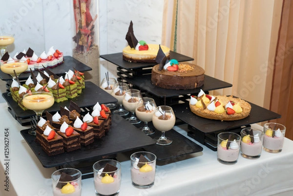 Fototapeta Party reception. Dessert buffet. A table filled with assortment of deserts. Catering for an event.
