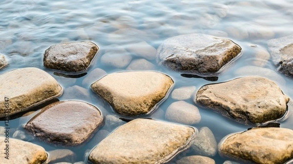 Fototapeta Smooth pebbles resting in tranquil water nature setting photography peaceful environment close-up view serenity and calmness