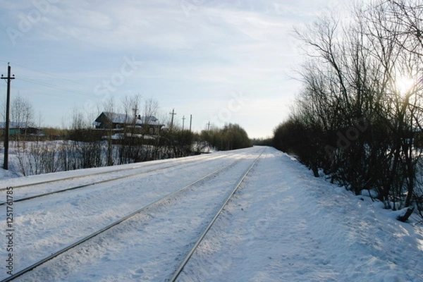 Fototapeta rail track next to a private sector in winter