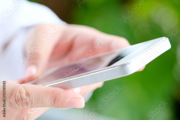 Fototapeta close up Image of Woman hand Using a Smart Phone background,communication