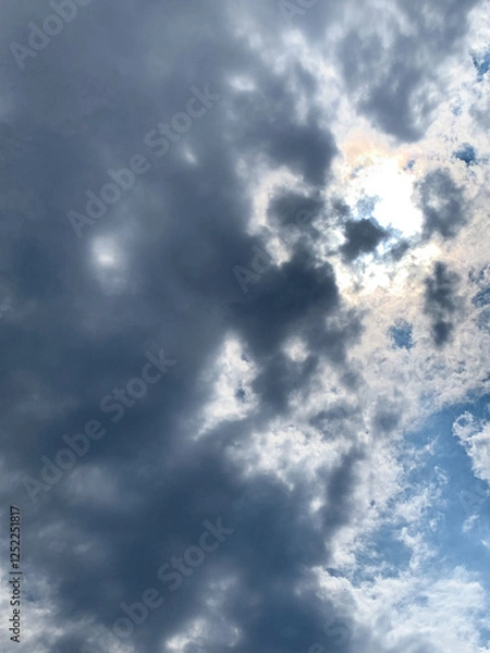 Obraz sun through clouds in blue sky