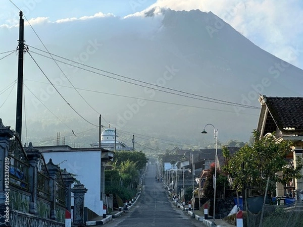 Obraz Beautiful rural view on a mountain slope with Mount Merapi in the background.