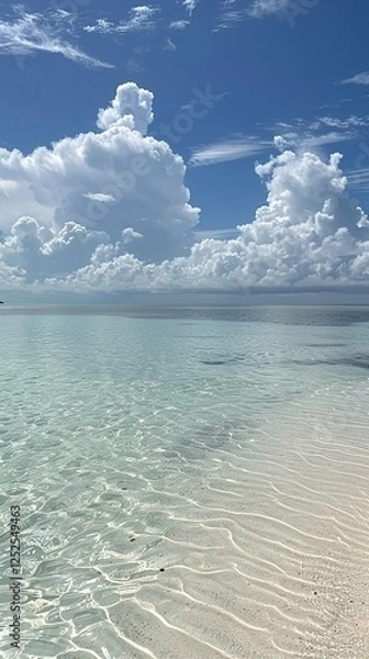 Fototapeta Serene ocean scene with crystal-clear waters and white sandy beaches, showcasing the beauty of nature's landscapes. Blue sky with fluffy clouds adds to the picturesque appearance