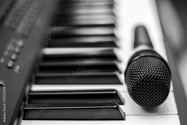 Fototapeta Close up microphone on piano keyboard in music studio. Music concept.