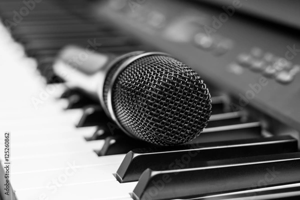 Obraz Close up microphone on piano keyboard in music studio. Music concept.