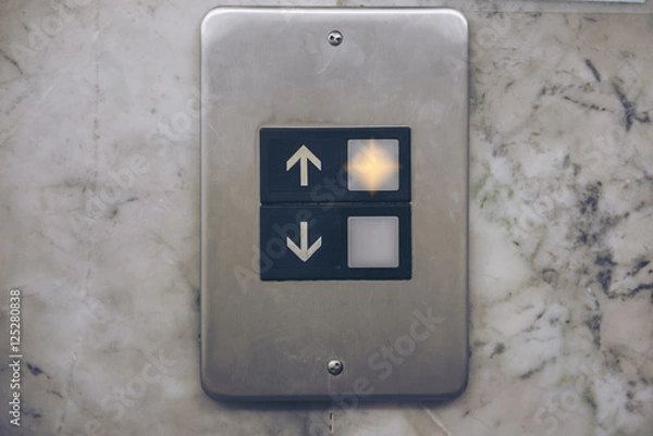 Obraz elevator button on the limestone walls.