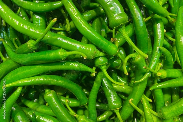 Obraz Green peppers on the grocery store counter.