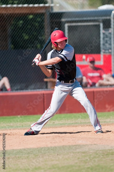 Fototapeta High school baseball player batting