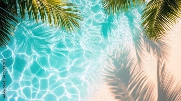 Fototapeta A bird's eye view of the beach with palm leaves and palm tree shadows on the sand and turquoise water, suitable for product backgrounds, summer vacation concept