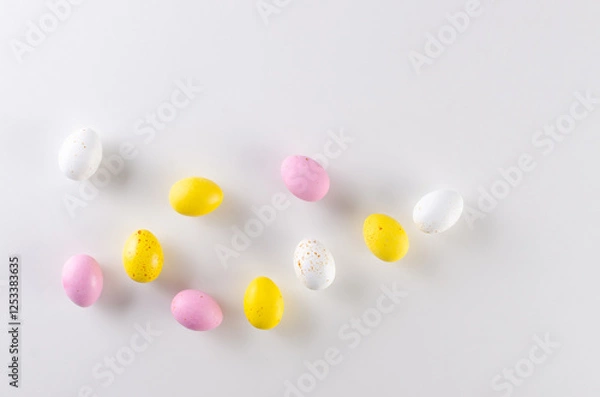 Obraz Happy Easter concept! Colorful Easter chocolate eggs on white. Easter greeting card, spring template.