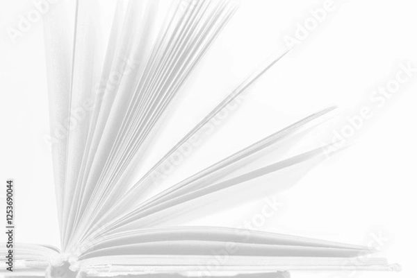 Fototapeta Open book with turning pages showcasing the elegance of literature and storytelling in a minimalistic setting