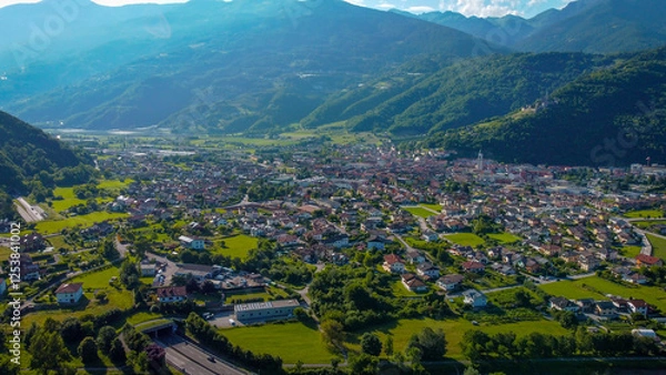 Obraz Aerial view of the town of Borgo Valsugana amidst the greenery of the mountains. Wonderful valley in Trentino, Italy