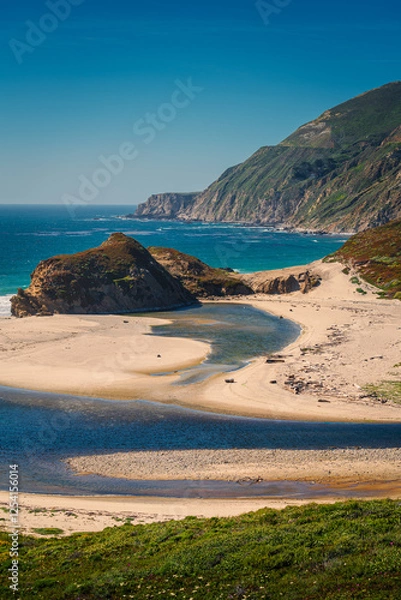 Obraz A beautiful beach scene with clear blue water, waves crashing on the sand, a coastline view with cliffs and rocks, perfect for a summer vacation in Big Sur California