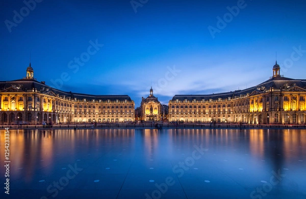 Fototapeta Bordeaux evening reflections showcasing illuminated architecture beside the water