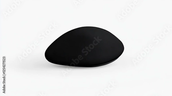 Fototapeta A smooth, abstract black stone-like object resting on a minimalist white surface