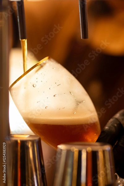 Obraz photo bartender - pulling choop of beer in a bar