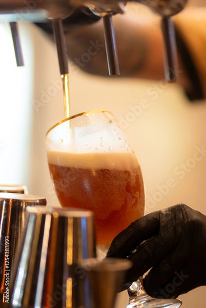 Obraz photo bartender - pulling choop of beer in a bar