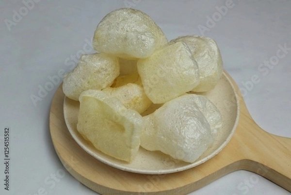 Fototapeta Crackers skin or cowhide, is a traditional Indonesian cracker served on a wooden plate