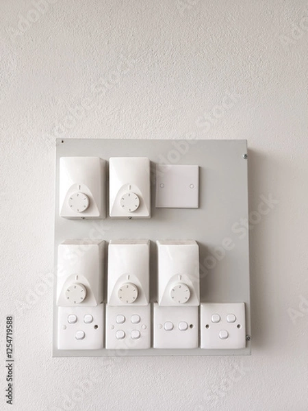 Fototapeta Modular Switches for home stock images. White electricity switch and socket board isolated.