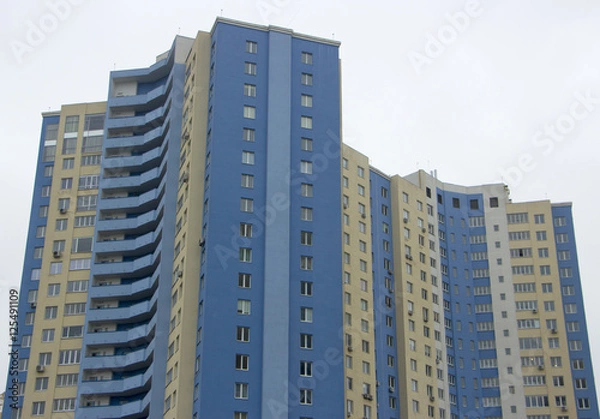 Fototapeta Multi-storey residential building on a background of the sky