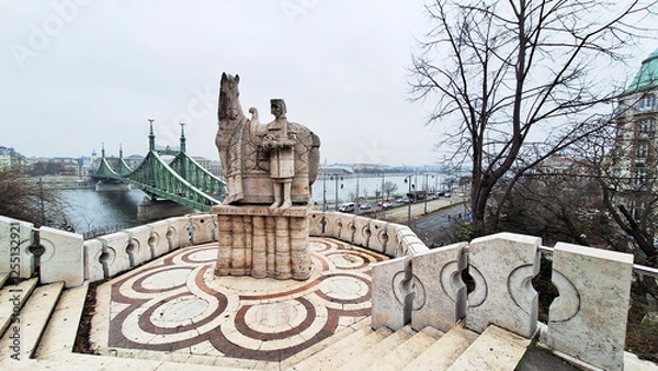 Obraz Stone statue of King Saint Steven outside the Gellert Hill Cave in front of the Liberty Bridge. Gellert Hill, Budapest, Hungary, Europe.