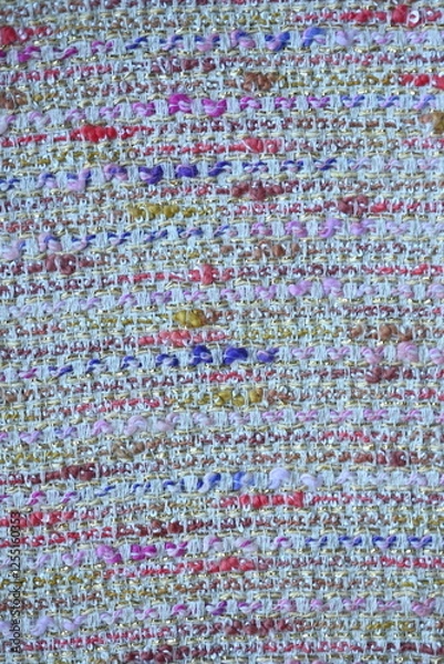 Fototapeta tweed beige  fabric as a macro background, suit polyurethane melange multicolored, knitwear wool stitch blue as a background 