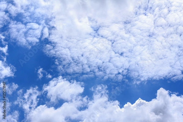 Obraz Blue sky background with white clouds. The vast blue sky and clouds sky on sunny day. White fluffy clouds in the blue sky.