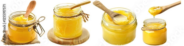 Fototapeta Four jars of ghee with wooden spoons, showcasing different sizes and textures of the sweet, golden substance.