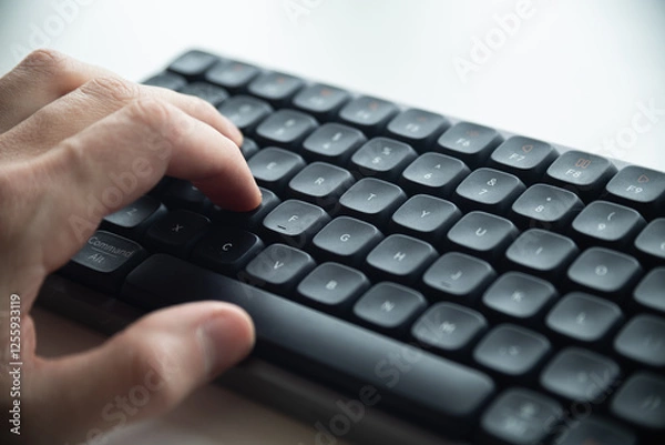 Obraz Close up of a man's hands on keyboard of lap top in the dark room, people working at home, modern white notebook. Internet, work, technology concept.