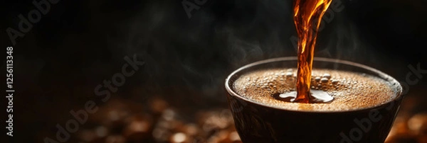 Fototapeta Coffee pours from cezve, creating a textured stream against a dark background