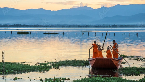 Obraz Novice monks row a boat in the lake,Phayao,Thailand