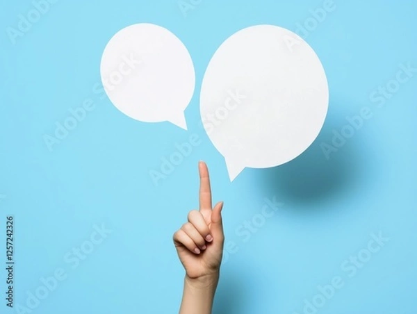 Fototapeta Finger pointing to two speech bubbles.