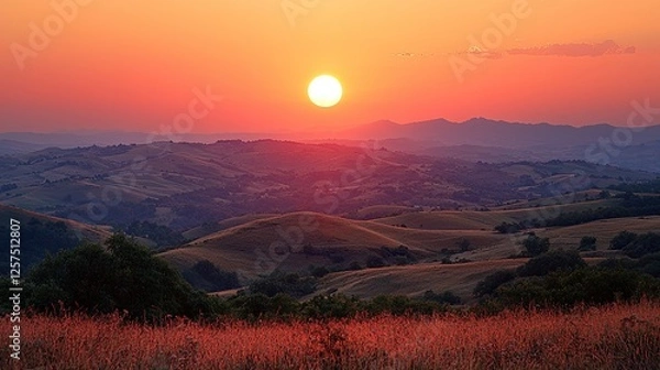 Obraz Serene sunset over rolling hills with vibrant colors and silhouetted landscape in the background