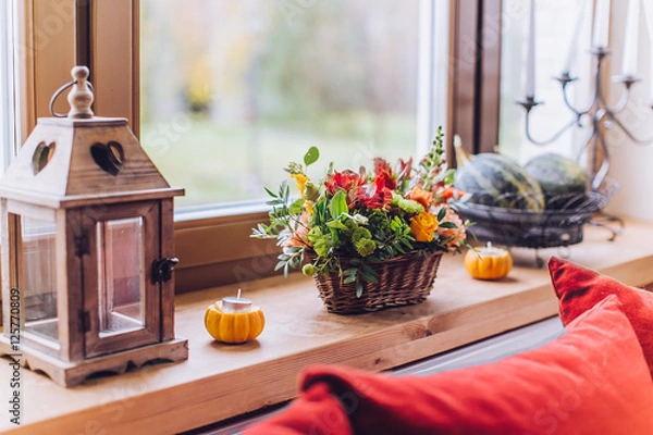 Fototapeta Window sill decorated with pumpkins and a flowerpot