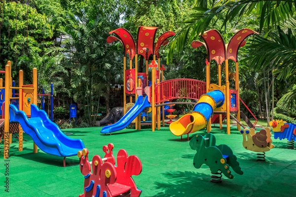 Fototapeta Colorful Playground with Green Elastic Rubber Floor in the Park