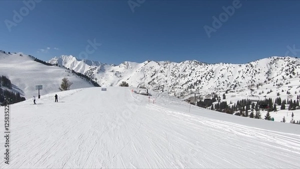 Obraz Winter Scene Of A Busy Ski Slope With Thrilling People Skiing Down Amidst Snowy Landscape