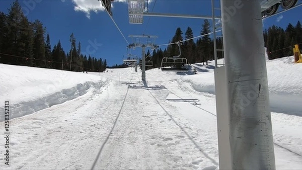 Obraz Winter Landscape With Ski Lift Ascending On A Snow-covered Hill Under A Clear Sky