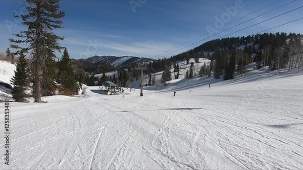Obraz Enthusiastic Skier Making Their Way Down A Snow-covered Hill In Winter