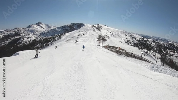 Obraz Adventurous Skier Descending A Snow Covered Mountain On A Clear Winter Day