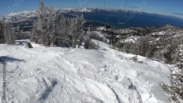 Obraz Scenic View Of A Ski Lift Ascending The Snow-covered Mountain Under Clear Blue Skies
