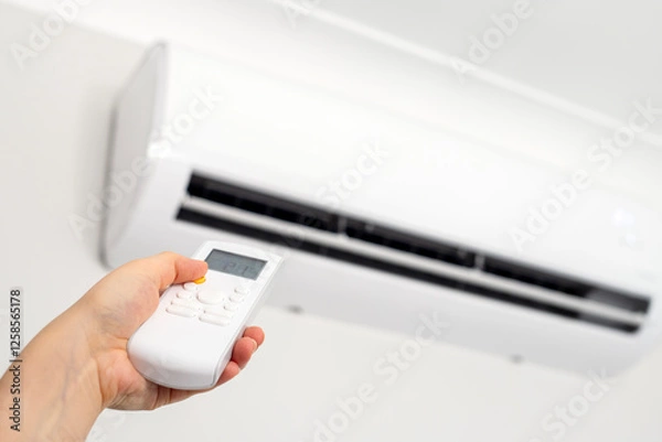 Fototapeta Concept of turning on or off ac or air conditioner by remote control.