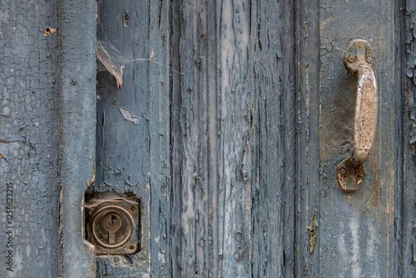 Obraz part of an old door with a rusty lock and handle covered in cobwebs
