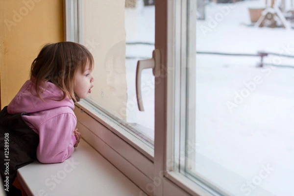 Obraz Girl and winter behind window.